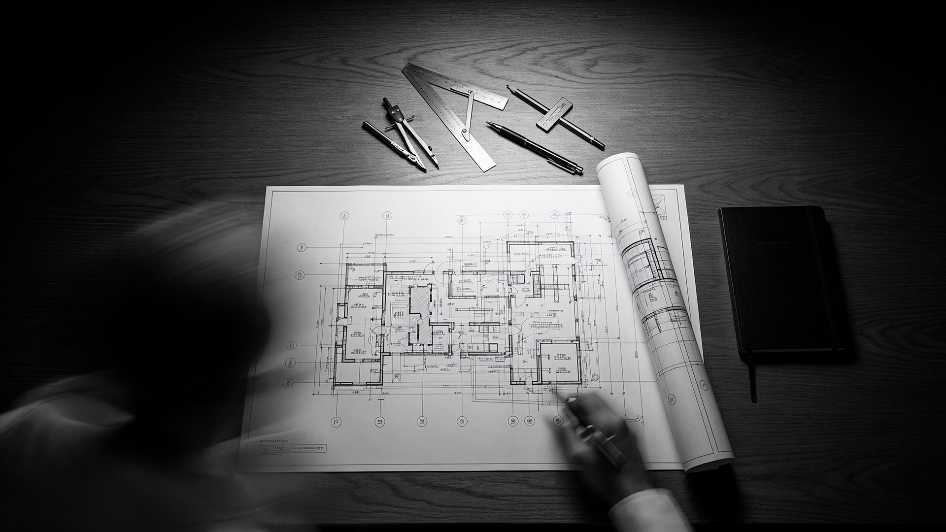 An architect's desk with an illuminated blueprint, symbolizing Presentation Studio's 